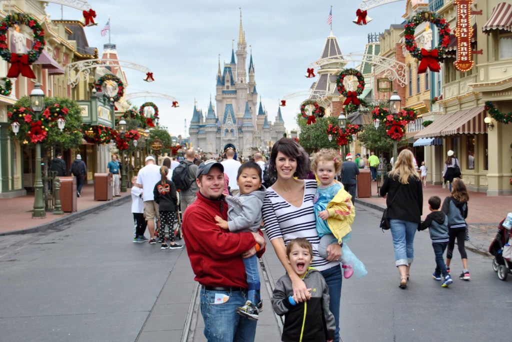 family in front of disney castle