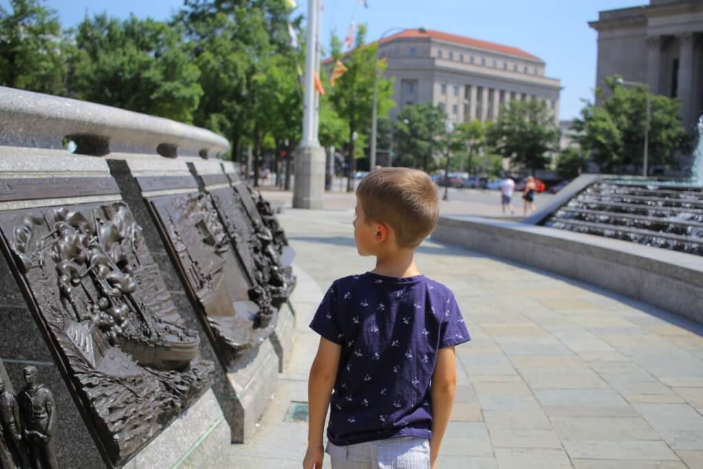 Little boy looking at navy plaques
