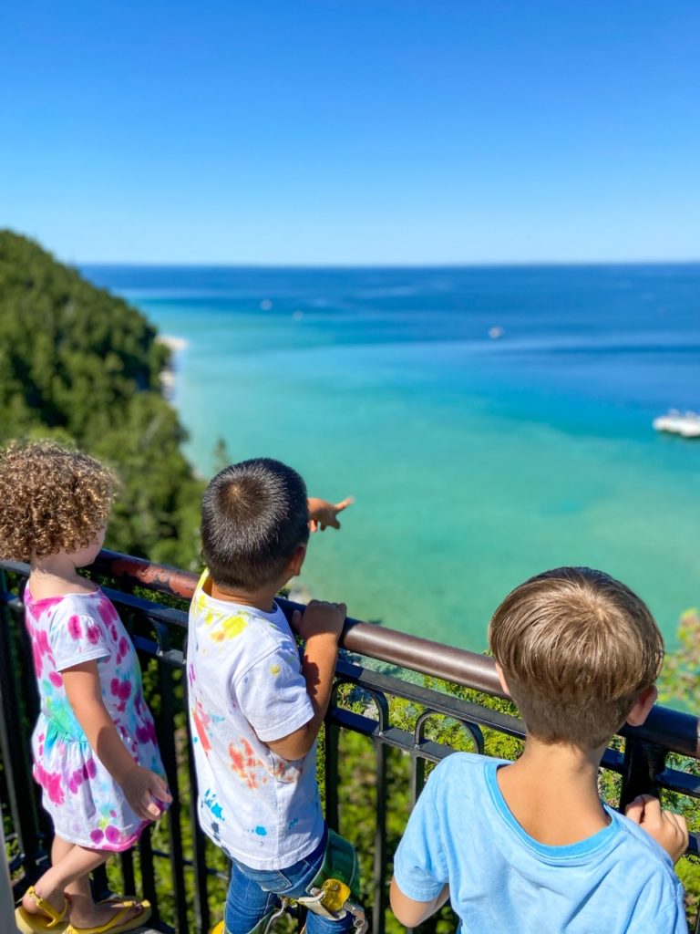 kids overlooking clear water