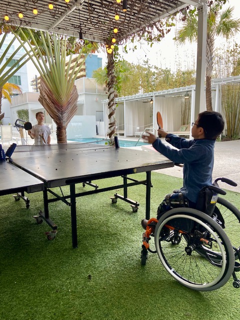 boy in wheelchair playing ping pong