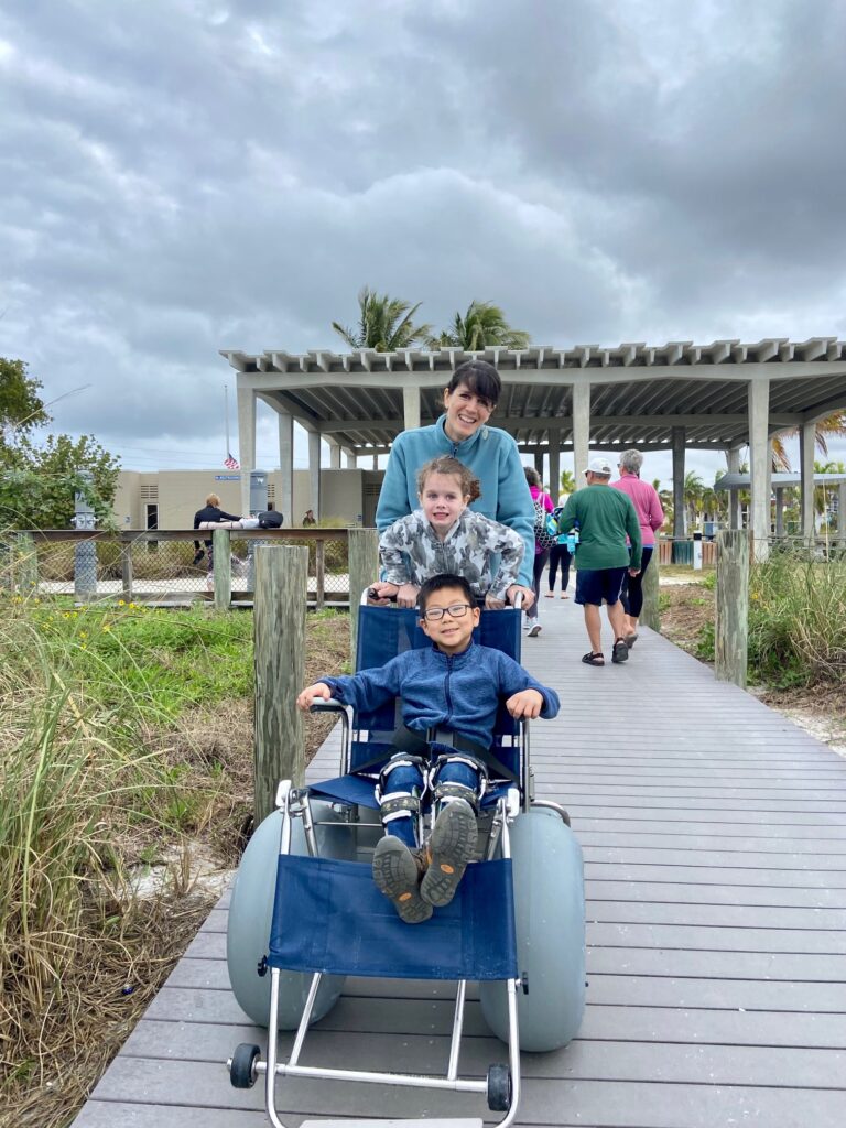 beach wheelchair with children and mom
