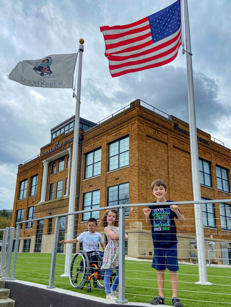 three children outside the schoolhouse hotel