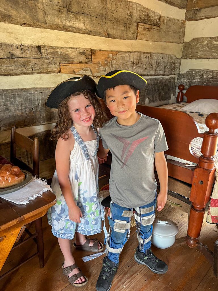 brother and sister in colonial hats