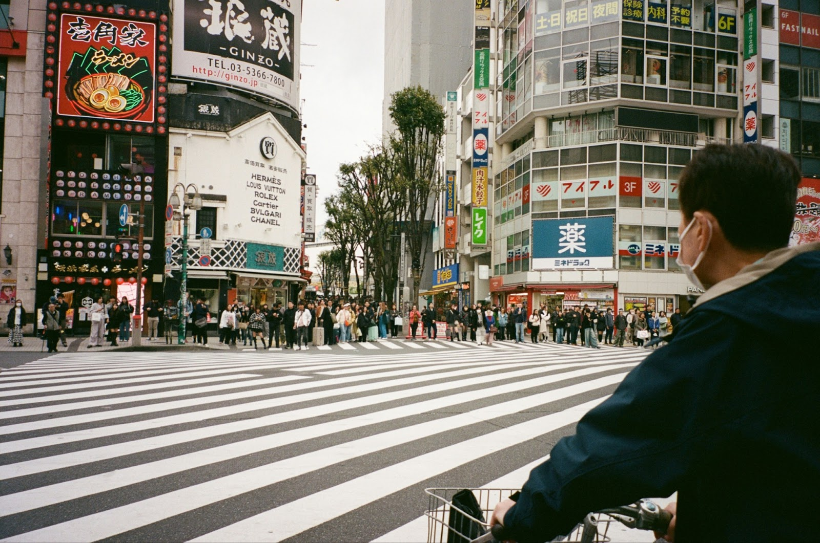 crowds of people waiting to cross Asian street