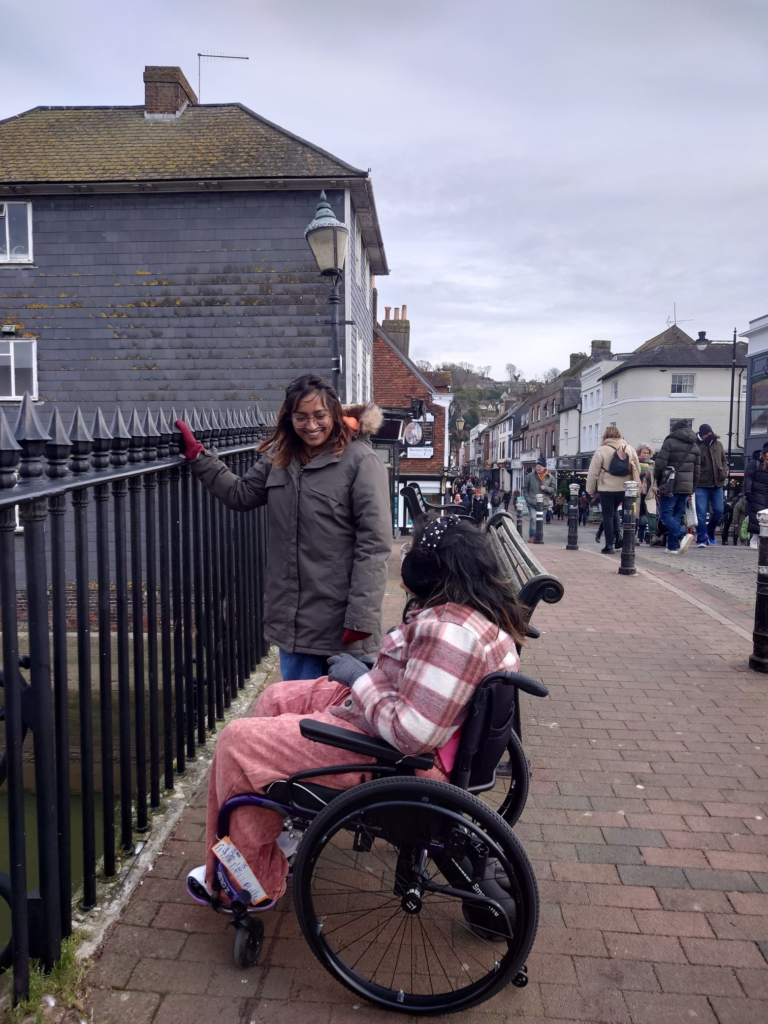 Hasitha chats with her friend on a scenic London street.