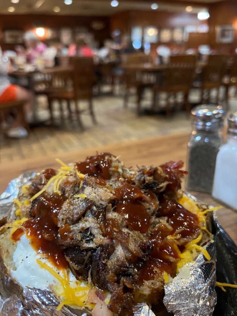 close up of BBQ pork piled on a potato