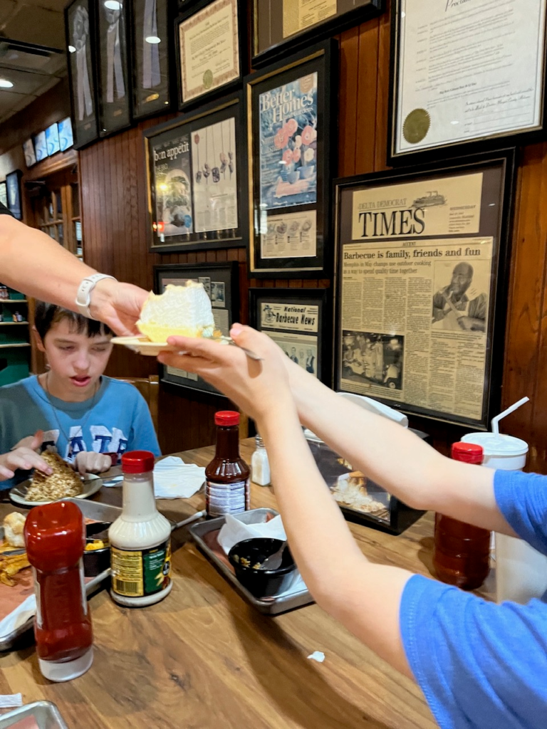 server handing pie to little boy