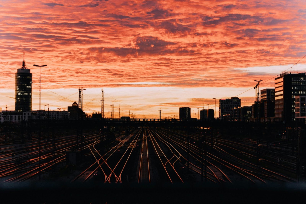 City scape around train tracks, sun setting in background
https://unsplash.com/photos/silhouette-of-city-buildings-during-sunset-zUVAbVni5_s?utm_content=creditShareLink&utm_medium=referral&utm_source=unsplash